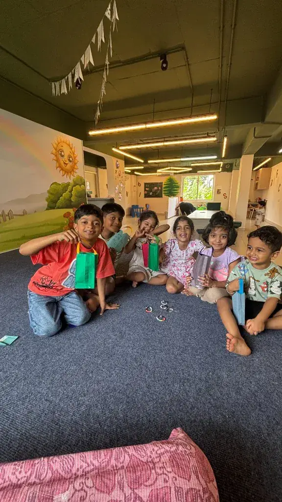 ULTRA_school children sitting in a circle showing the craft bags they made